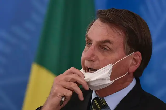 Populist leader adjusting face mask during pandemic